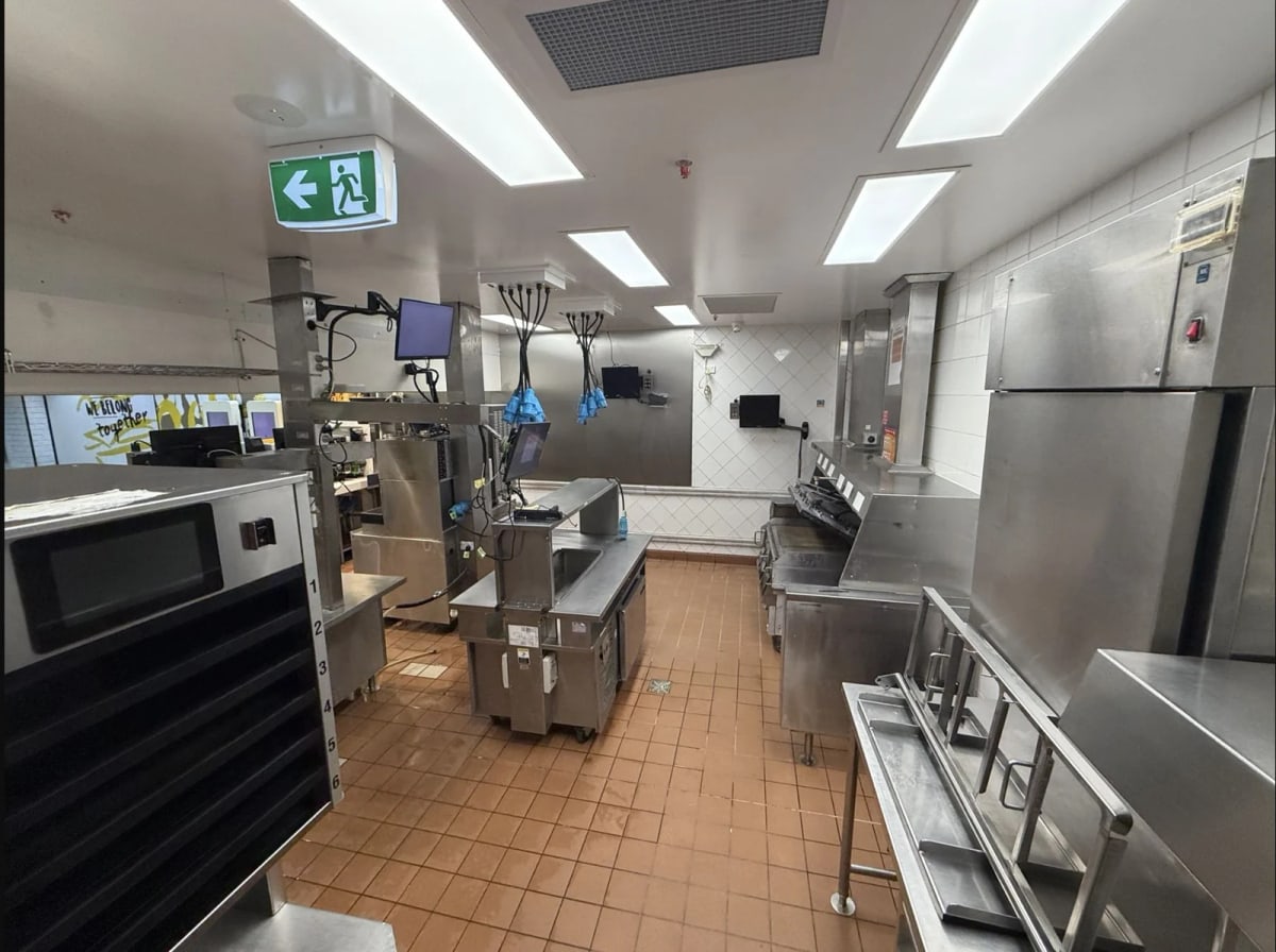 McDonald’s commercial kitchen with stainless-steel work areas and tiled flooring