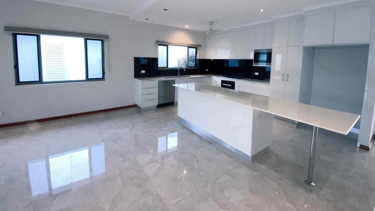 Clean rental kitchen and living area prepared for handover